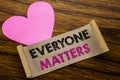 Writing text showing Everyone Matters. Business concept for Equality Respect written on sticky note paper, wooden wood background.