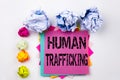 Writing text showing Human Trafficking written on sticky note in office with paper balls. Business concept for Slavery Crime Royalty Free Stock Photo