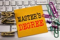 Writing text showing Master s Degree. Business concept for Academic Education written on sticky note paper on the white keyboard b Royalty Free Stock Photo