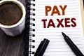 Writing text showing Pay Taxes. Business concept for Taxation Overtax Return written on notebook book note paper on the wooden woo