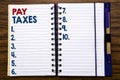 Writing text showing Pay Taxes. Business concept for Taxation Overtax Return Written on notebook note paper, wooden background wit