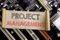 Writing text showing Project Management. Business concept for Strategy Plan Goals Written on sticky note, computer main board back Royalty Free Stock Photo