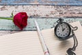 Writing time for love: red rose, journal, pen, and pocket watch Royalty Free Stock Photo