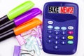 Writing word Fake News text in the office with surroundings such as marker, pen writing on calculator. Business concept for Propag Royalty Free Stock Photo