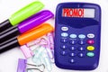 Writing word Promo text in the office with surroundings such as marker, pen writing on calculator. Business concept for Promo Sale