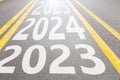 2023 and 2024 and 2025 written on the asphalt road going forward in Ukraine, the beginning of the new year and the way