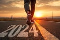 2024 written on asphalt road and a runner starting the new year. Concept of challenge or career path and change