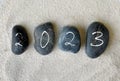 2023 written on black pebbles