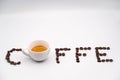 Written CaffÃ¨ with coffee beans and a cup of coffee instead of the letter O