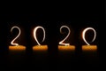 2020 written with candle flames on black background greeting card Royalty Free Stock Photo