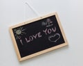 Written chalk on a school blaclboard, confession of love ` I Love You `