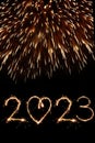 2023 Happy New Year eve text of Sparkle firework on black night sky. Fireworks and illumination celebration. Royalty Free Stock Photo