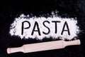 On written flour pasta. Dark background. Rolling pin. On written flour pasta. Broken egg. Spilling pasta. Royalty Free Stock Photo