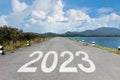 2023 written on highway road  in the middle of empty asphalt road and beautiful blue sky. New year 20223 Royalty Free Stock Photo