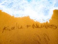 Written name on the beach by couple.