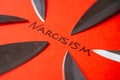 Written Narcisism, with knife blades next to it Royalty Free Stock Photo
