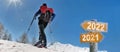 2022 written on a postsign with a man in touring ski Royalty Free Stock Photo