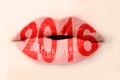 2016 written with red lipstick on lips