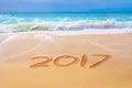 2017 written on the sand of a beach, travel new year concept