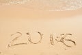 2016 written on sand. Beach and waves Royalty Free Stock Photo