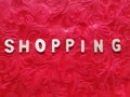 Written: shopping, on a red background