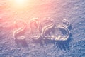 2023 written in the snow illuminated by sunlight. New year and christmas concept