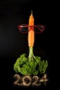 2024 written with spaklers, under a carrot looking like a rocket with eye glasses . Funny Creative concept on black background