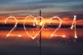 2021 written with Sparkle firework on sunset background, happy new year 2021 concept Royalty Free Stock Photo