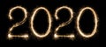 2020 written with sparkling holiday font on black background