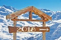 2018 written on a wood direction sign, snow mountain landscape on the background