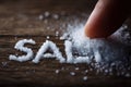 Written the word SALT in the grains of salt on the table. Generative AI. Royalty Free Stock Photo