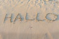 Written words Hallo on sand of beach Royalty Free Stock Photo