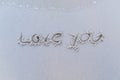 Written words `Love you` on sand of beach. Royalty Free Stock Photo