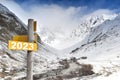 2023 written on yellow postsign on mountain