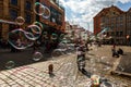 Man launches soap bubbles entertain tourists in the old city cen Royalty Free Stock Photo