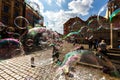 Man launches soap bubbles entertain tourists in the old city cen Royalty Free Stock Photo