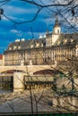 Facade of beautiful building of Wroclaw University next to Odra river seen from behind sticks of