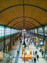 First floor balcony view to interior of main railway station building full of people and open