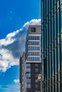 Perspective view to facades of modern corporate building with glass facade with high skyscraper