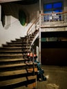 Spiral staircase with big skylight in ceiling and old wooden stairs