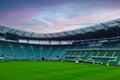 Wroclaw, Poland, August 25, 2021: picturesque sunset at the stadium. Football green field. Empty stands.