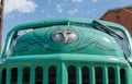 WROCLAW, POLAND - August 11, 2019: USA cars show: Old Dodge car. Green Vintage renovated hood with logo against blue sky. Close-up Royalty Free Stock Photo