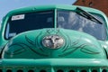 WROCLAW, POLAND - August 11, 2019: USA cars show: Old Dodge car. Green Vintage renovated hood with logo against windshield. Close- Royalty Free Stock Photo