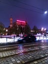Wroclaw, Poland - December 7 2023: Beautiful and colorfully glowing light stripes of tram and cars at tram station next to main