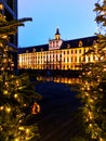 Facade of University of Wroclaw building reflecting in Odra river at afternoon with christmas