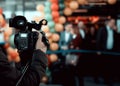 Camera operator filming an event using Sony digital camera 