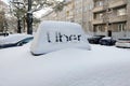Wroclaw, Poland, December 1, 2023: snow-covered taxi car and Uber sign. Royalty Free Stock Photo