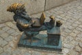 WROCLAW, POLAND: Dwarf is sitting and reading a book, famous bronze miniature gnome with hat sculpture