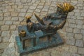 WROCLAW, POLAND: Dwarf is sitting and reading a book, famous bronze miniature gnome with hat sculpture