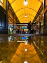 Long corridor inside main railway station reflected in puddle